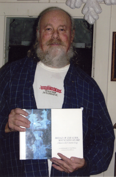 Portrait of Chuck Williams holding his book Bridge of the Gods, Mountains of Fire: A Return to the Columbia Gorge, Chuck Williams Photographs
