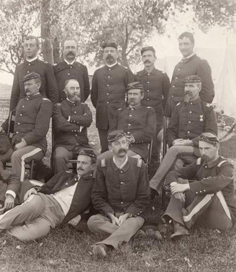 Cavalry officer group posed in woods. Frazier Boutelle at right, seated, with one medal and two bars on shoulder patch., Frazier A. Boutelle photographs, c. 1865-1924