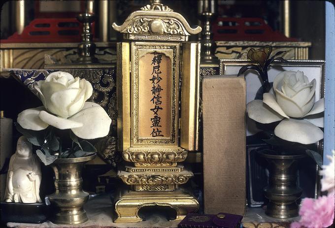 Close-up of picture of Buddha in shrine