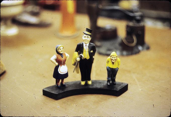 Three hand whittled figures on a platform. Carved from mahogany, painted by Eleanor Lofton, VR's daughter (3 in-7 in tall)