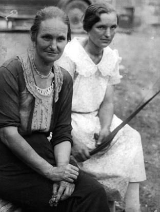 Two women, seated outside