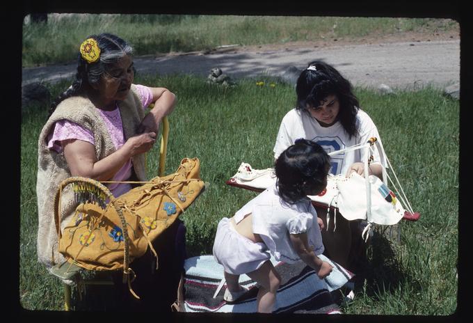 Priscilla Bettles (left) and Priscilla Witcraft, each with cradleboard. Toddler visible