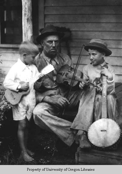 Man with fiddle, young boys with banjo and ukelele