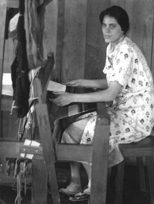 Jane Chase, spinner and weaver, at the loom