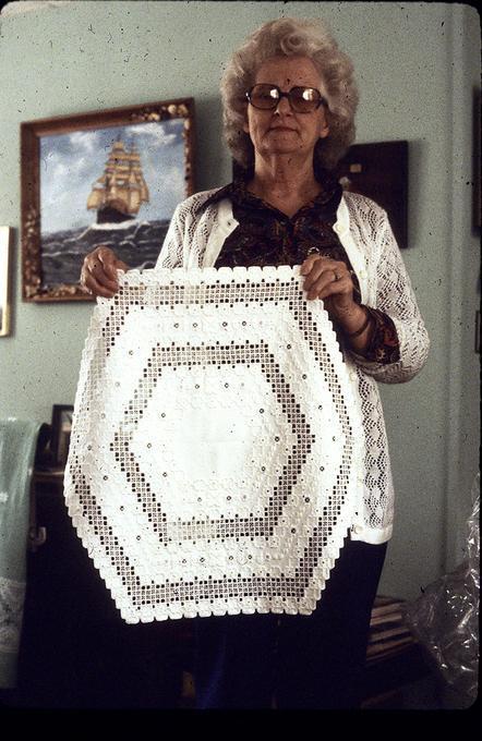 Original six sided piece of embroidered Hardanger cloth, made for her children who own a six-sided table. She invented how to do it, using traditional shapes, and is real proud of this one. Made 1979.