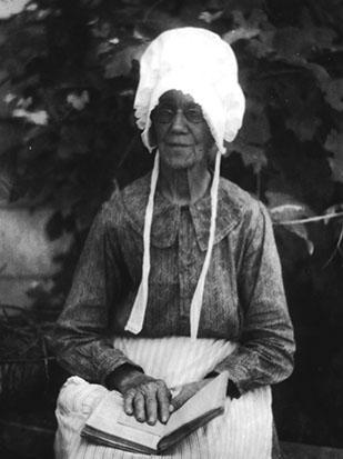 Elderly African-American woman, wearing bonnet