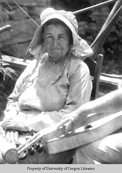 Martha Nichols, spinner and weaver, with wheel