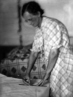 Mrs. C.U. Wood, leader of spread making enterprise, at work