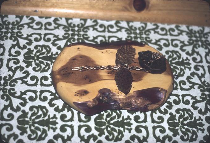 Brass flower plaque on wall of alcove