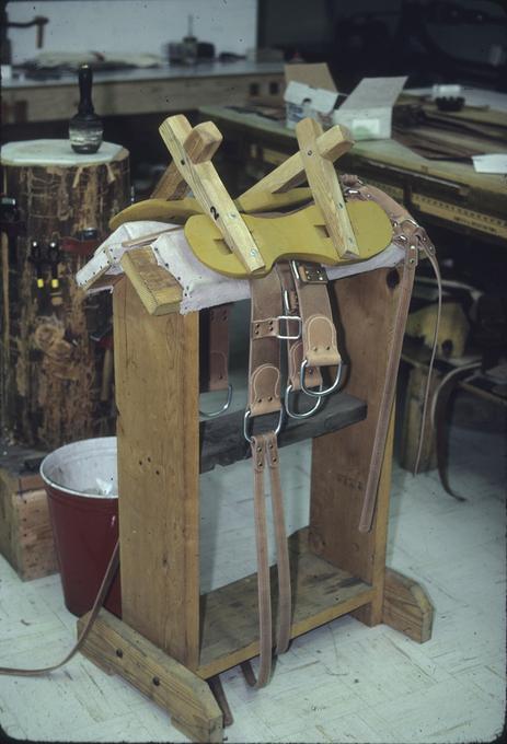 Sawbuck type pack saddle frame, on straps and stand