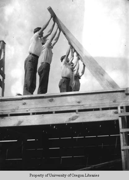 Students building a house, Berea College: raising wall