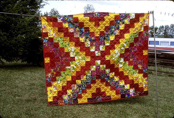 65 x 85 inch started by Emma Jensen's daughter in Can.(?). Sent squares to family and friends, got pieces back for Emma Jensen's birthday in 1939 but never got around to quilt it. Hattie and Marguerite quilted it about 1955. (Don't know why 1966 is on it.) Junction City