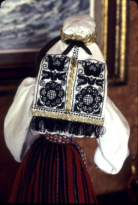 Back of head of doll in Ambla costume, showing embroidery