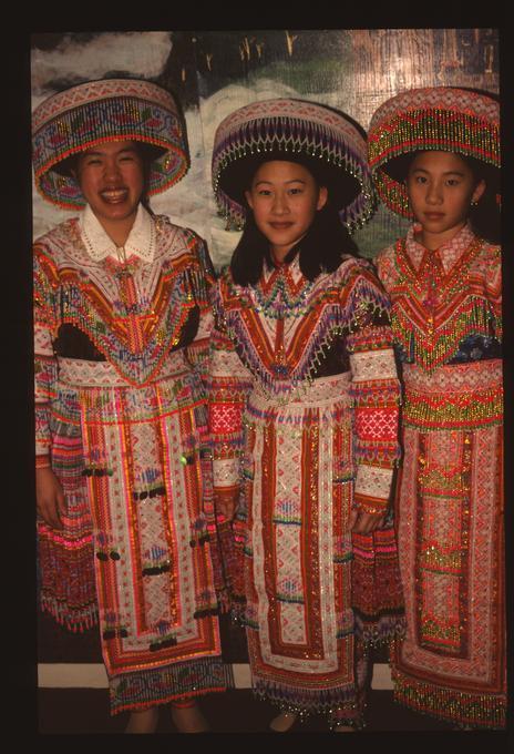 Asian Family Center, men and women in traditional Hmong ceremonial clothing