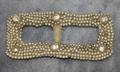 Belt buckle of faux pearl beads with net backing