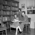 Faith Norris and Bernard Malamud seated by bookshelf