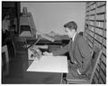 Rodney Waldron with new portable microfilm reader, December 1958