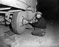 Bob Coons changing tire on Pierce Freight Lines truck