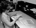 Student putting records in order for filing