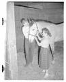 Students Gayle Davidson and Leroy Martin posing with a horse