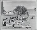 Students sunbathing on the roof of Snell Hall