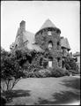 Large stone house, with ivy-covered tower in foreground. Home of Dr. Kenneth MacKenzie.