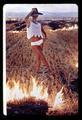 Woman standing in burning field, Corvallis, Oregon, March 1969