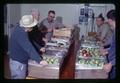 Orchardist assisting Superintendent Walt Mellenthin in evaluation of experimental fruit, Mid-Columbia Experiment Station, Oregon State University, Hood River, Oregon, circa 1970