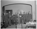 ROTC students and President Jensen posing with summer camp trophies, September 1961