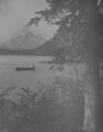 Mt. Hood in background, lake & boater in foreground.