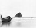 Men and boats on ocean beach near Cannon Beach