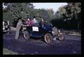 President James Jensen and Chris Jensen being pushed in an antique car at OSU Centennial parade, Corvallis, Oregon, October 26, 1968