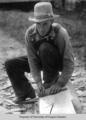 Mr. Stewart, cross-tie maker, working a log