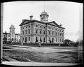 Portland Post Office from corner of 6th and Yamhill. Three men in doorway of building, fence around grounds. Central School in background.