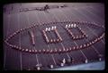 Oregon State University Marching Band shaped like a football surrounding the number 100, circa 1969