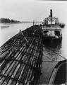 Large Log Raft and Boats (The Shaver) Along Pier