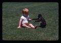 Child and spider monkey in park, Bend, Oregon, 1974