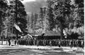 Kyle Canyon CCC camp members stand at attention as the flag is lowered, Nevada National Forest
