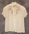 Blouse of ivory silk with standing band collar with open-work, floral vine embroidery