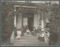 Women sitting on the front porch and steps of Alpha Hall