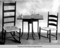 Table and caned chairs, with doll and toy spinning wheel