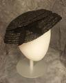 Cartwheel hat of woven black straw with velour ribbon bow at side