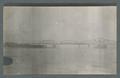 Truss bridge, ocean in background, viewed from river, circa 1910