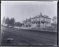 Louise Home for Girls, Elwood Station, Portland. Large house in residential area, with picket fence in foreground. Other houses in background.
