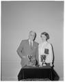 Earl W. Wells and Beverly Burgoyne with her speech contest trophies, 1960