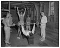 Members of the Beaver crew team lifting weights in the training barn