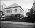 Side view, old Library building, Portland. Grounds surrounded by fence.