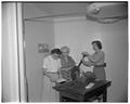 Clothing and textile workshop students working with machinery during summer school, July 1954