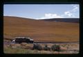 Truck watering road in front of ripening wheat on Kaseberg ranch, Sherman County, Oregon, 1974