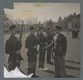 Cadet officer inspecting rifle squad, circa 1942